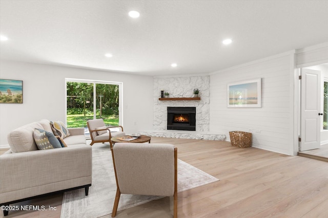2453 Jetty Ct, Jacksonville, FL 32233 - living room featuring wood finished floors, a stone fireplace, and recessed lighting
