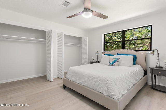 2453 Jetty Ct, Jacksonville, FL 32233 - bedroom with two closets, light wood-type flooring, and a ceiling fan