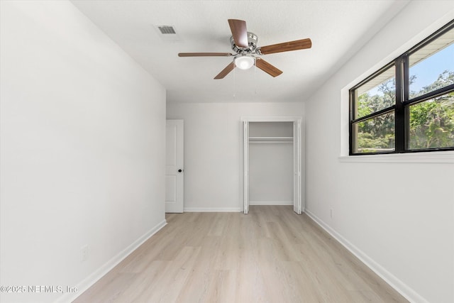 2453 Jetty Ct, Jacksonville, FL 32233 - unfurnished bedroom with light wood-style flooring, a closet, and a ceiling fan