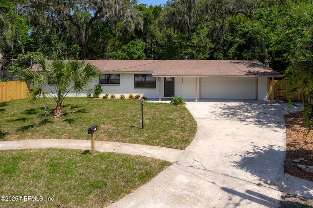 2453 Jetty Ct, Jacksonville, FL 32233 - ranch-style house featuring a garage, driveway, and a shingled roof