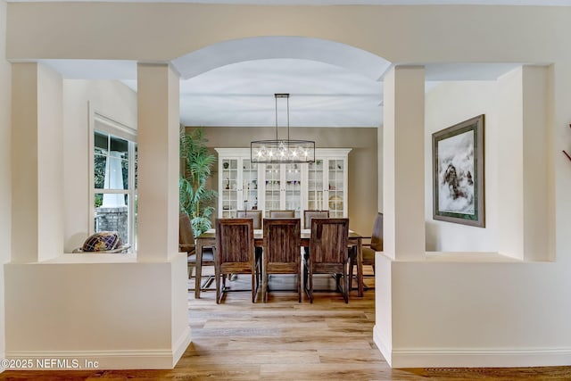 644 Sun Down Cir, Saint Augustine, FL 32080 - dining space featuring light wood-style flooring, arched walkways, and a chandelier