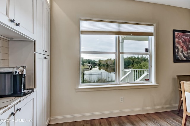 644 Sun Down Cir, Saint Augustine, FL 32080 - kitchen featuring white cabinets, wood finished floors, and light countertops