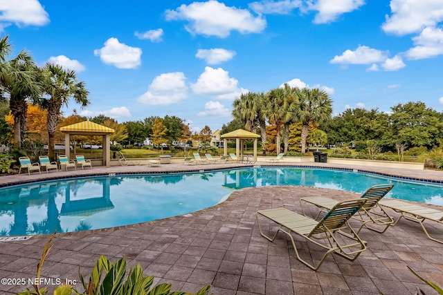 644 Sun Down Cir, Saint Augustine, FL 32080 - community pool featuring a gazebo, a patio area, and view of wooded area