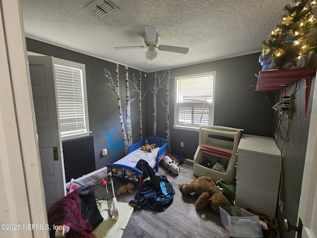 105 Owens Acres Dr, Macclenny, FL 32063 - bedroom featuring wood finished floors, a textured ceiling, and a ceiling fan