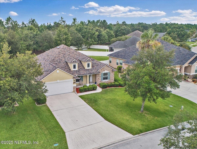 3504 Garibaldi Way, Saint Augustine, FL 32092 - traditional home with concrete driveway, stucco siding, stone siding, an attached garage, and a front yard
