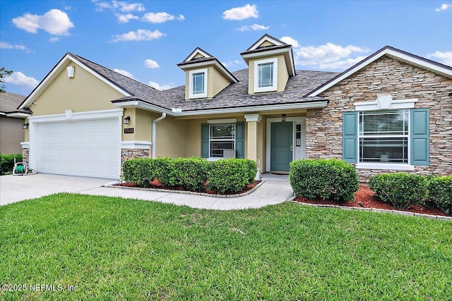 3504 Garibaldi Way, Saint Augustine, FL 32092 - view of front of home featuring stone siding, stucco siding, a front lawn, an attached garage, and driveway