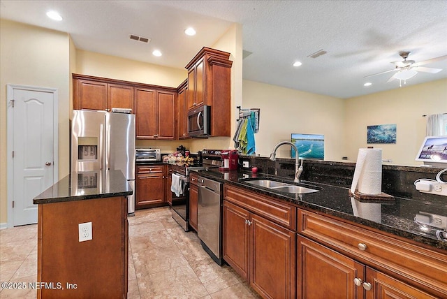 3504 Garibaldi Way, Saint Augustine, FL 32092 - kitchen featuring appliances with stainless steel finishes, a kitchen island, dark stone countertops, ceiling fan, and recessed lighting
