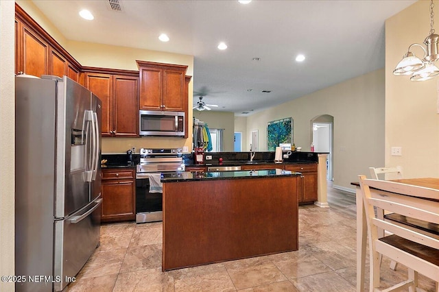 3504 Garibaldi Way, Saint Augustine, FL 32092 - kitchen with stainless steel appliances, arched walkways, dark countertops, ceiling fan, and recessed lighting