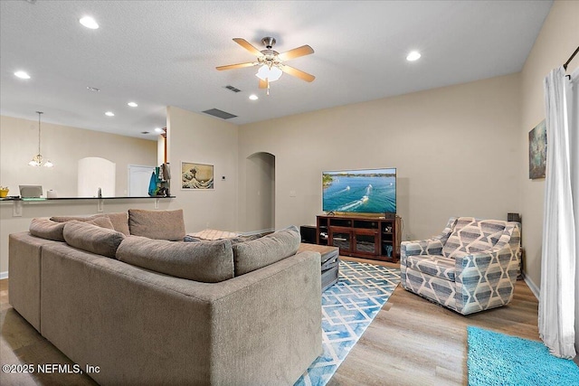 3504 Garibaldi Way, Saint Augustine, FL 32092 - living area with arched walkways, wood finished floors, a ceiling fan, and recessed lighting