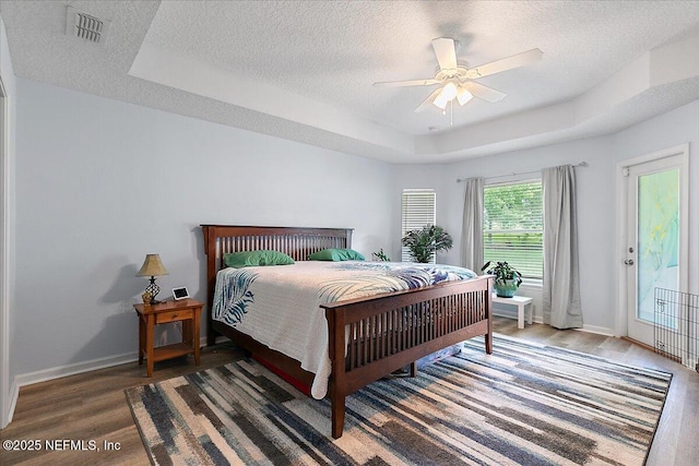 3504 Garibaldi Way, Saint Augustine, FL 32092 - bedroom with wood finished floors, a raised ceiling, a textured ceiling, and ceiling fan