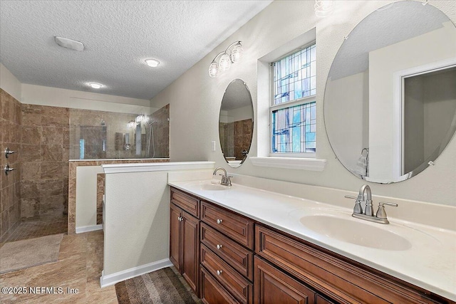3504 Garibaldi Way, Saint Augustine, FL 32092 - bathroom with a walk in shower, double vanity, and a textured ceiling
