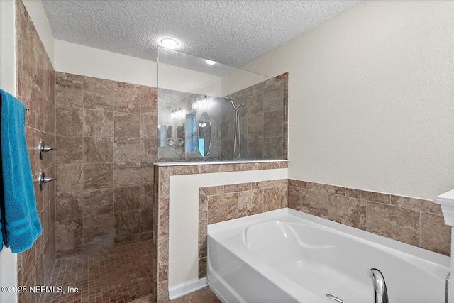 3504 Garibaldi Way, Saint Augustine, FL 32092 - bathroom with a garden tub, a textured ceiling, and walk in shower