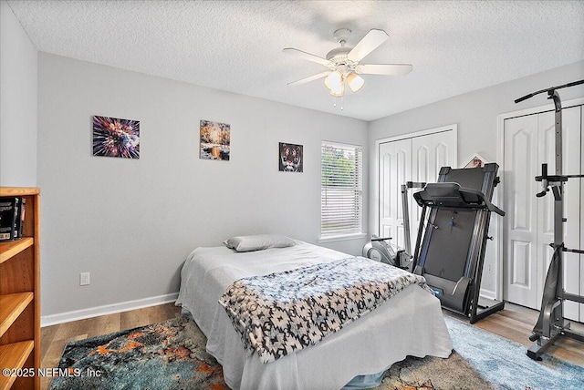 3504 Garibaldi Way, Saint Augustine, FL 32092 - bedroom featuring wood finished floors, two closets, a textured ceiling, and a ceiling fan