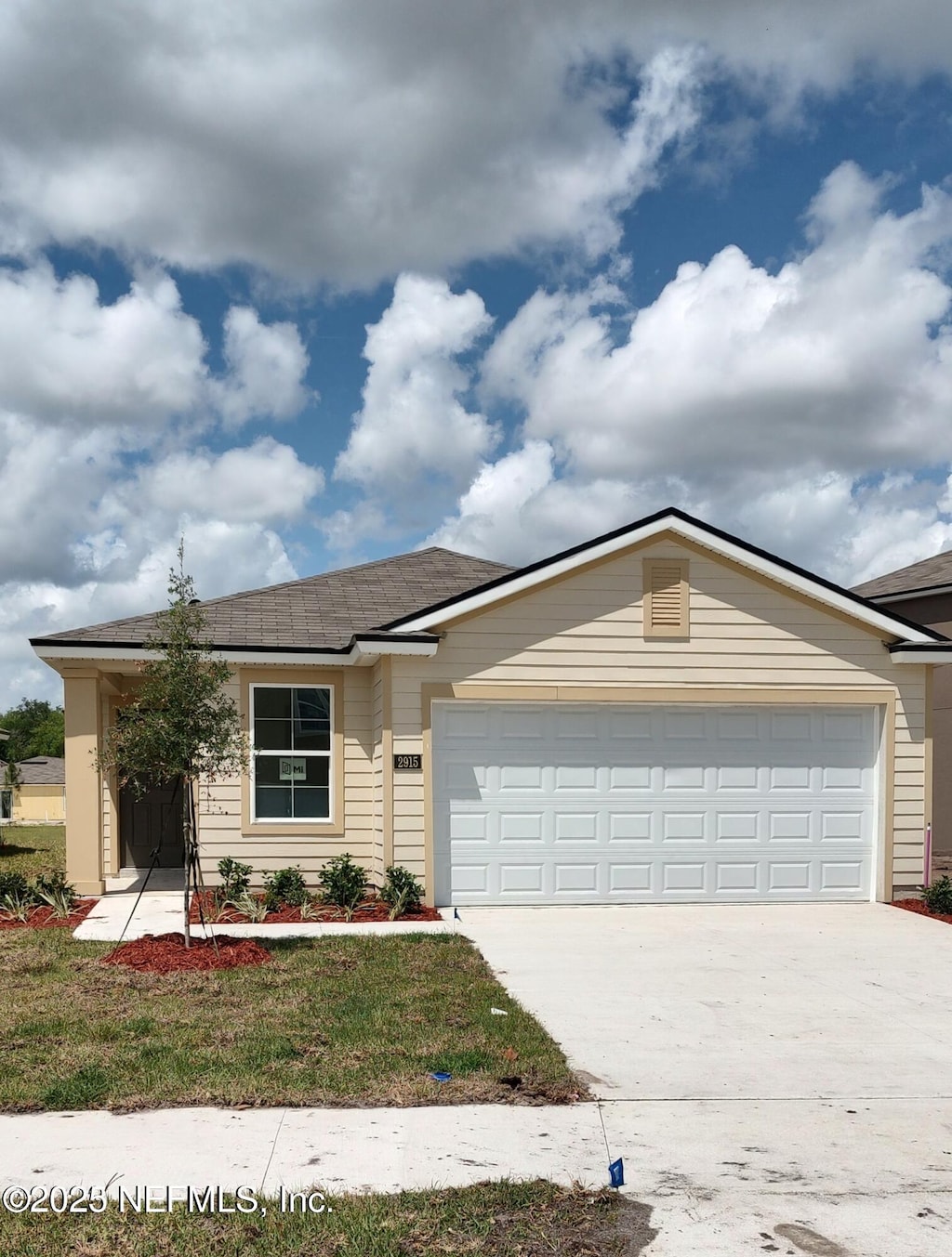 2915 Duck Hollow Ln, Green Cove Springs, FL 32043 - ranch-style house with an attached garage, concrete driveway, a shingled roof, and a front lawn