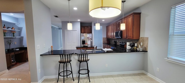 308 Winding Oak Way, Saint Augustine, FL 32084 - kitchen with stainless steel appliances, a peninsula, dark countertops, backsplash, and recessed lighting