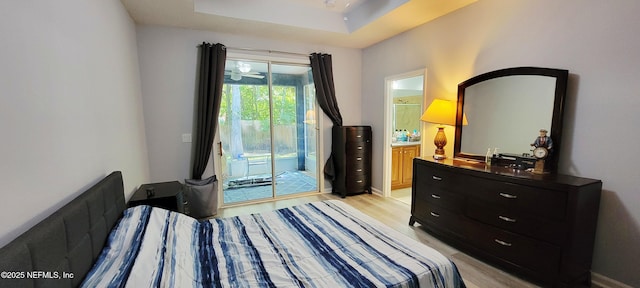 308 Winding Oak Way, Saint Augustine, FL 32084 - bedroom with access to exterior, light wood-type flooring, ensuite bath, and a tray ceiling