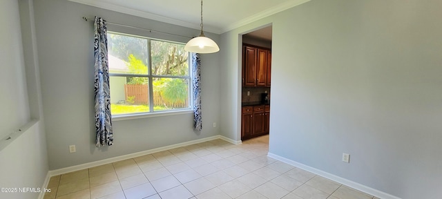 308 Winding Oak Way, Saint Augustine, FL 32084 - unfurnished dining area with crown molding and light tile patterned floors