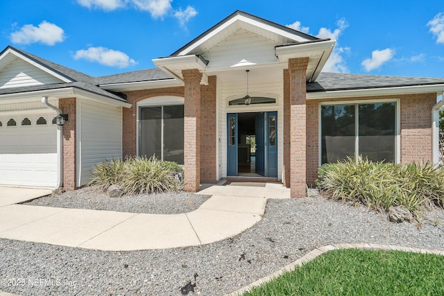 429 N Bridgestone Ave, Saint Johns, FL 32259 - view of exterior entry featuring brick siding, roof with shingles, and an attached garage