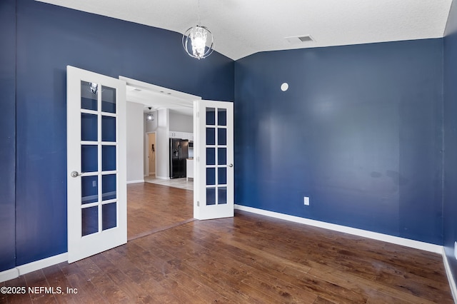 429 N Bridgestone Ave, Saint Johns, FL 32259 - empty room featuring french doors, vaulted ceiling, and wood finished floors