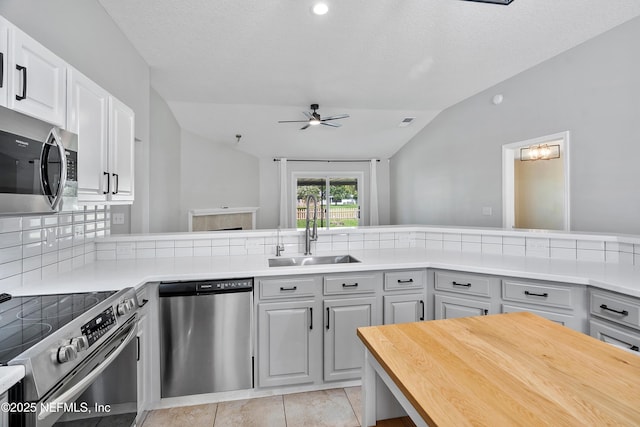 429 N Bridgestone Ave, Saint Johns, FL 32259 - kitchen with appliances with stainless steel finishes, vaulted ceiling, a ceiling fan, backsplash, and wooden counters