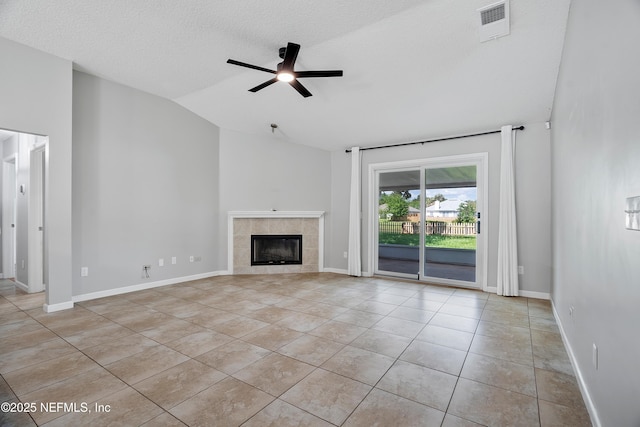429 N Bridgestone Ave, Saint Johns, FL 32259 - unfurnished living room with vaulted ceiling, light tile patterned floors, ceiling fan, a tiled fireplace, and a textured ceiling