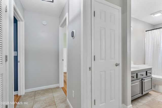 429 N Bridgestone Ave, Saint Johns, FL 32259 - corridor featuring light tile patterned flooring and a textured ceiling