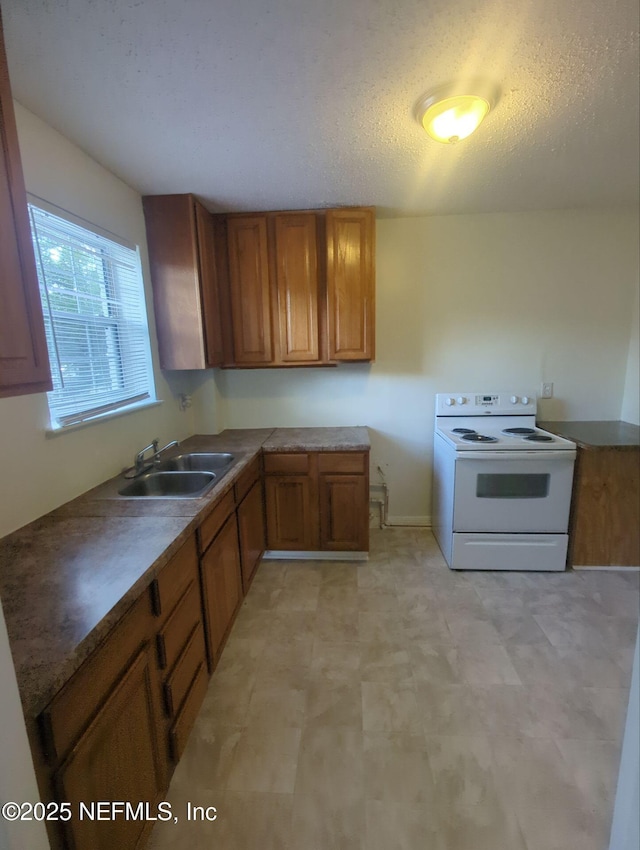 3136 Post St, Jacksonville, FL 32205 - kitchen featuring electric range, brown cabinets, light floors, and a textured ceiling
