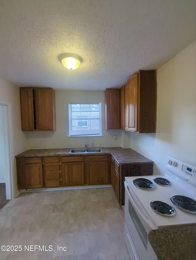 3136 Post St, Jacksonville, FL 32205 - kitchen featuring white range with electric cooktop, brown cabinets, and a textured ceiling