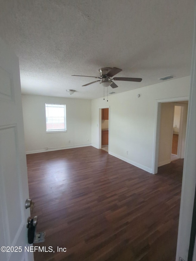 3136 Post St, Jacksonville, FL 32205 - empty room featuring dark wood-type flooring, a ceiling fan, and a textured ceiling