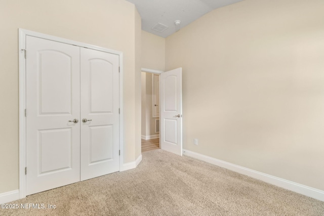 78262 Saddle Rock Rd, Yulee, FL 32097 - unfurnished bedroom with carpet flooring, a closet, and vaulted ceiling