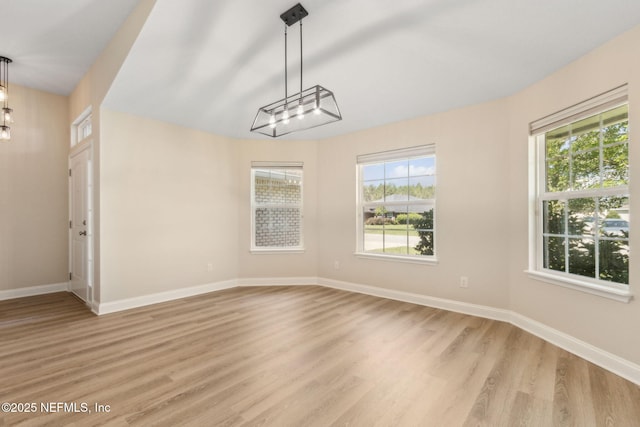 78262 Saddle Rock Rd, Yulee, FL 32097 - spare room with plenty of natural light, light wood-style flooring, and a chandelier