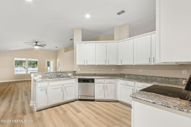 78262 Saddle Rock Rd, Yulee, FL 32097 - kitchen with stainless steel dishwasher, a peninsula, light wood finished floors, white cabinetry, and lofted ceiling