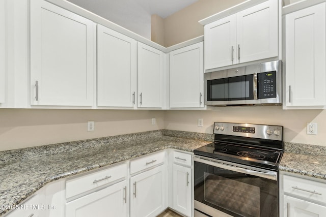 78262 Saddle Rock Rd, Yulee, FL 32097 - kitchen with stainless steel appliances, white cabinetry, and light stone countertops