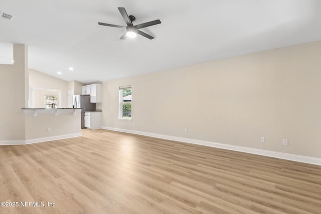 78262 Saddle Rock Rd, Yulee, FL 32097 - unfurnished living room with a ceiling fan, vaulted ceiling, and light wood-style floors