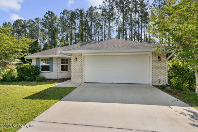 78262 Saddle Rock Rd, Yulee, FL 32097 - single story home featuring concrete driveway, brick siding, a front yard, an attached garage, and a shingled roof