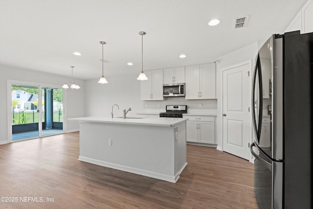 82 Birchfield Ln, Saint Augustine, FL 32092 - kitchen featuring stainless steel appliances, recessed lighting, white cabinetry, wood finished floors, and light countertops