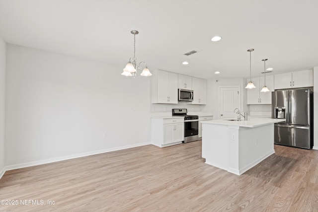 82 Birchfield Ln, Saint Augustine, FL 32092 - kitchen with appliances with stainless steel finishes, light countertops, light wood finished floors, recessed lighting, and white cabinets