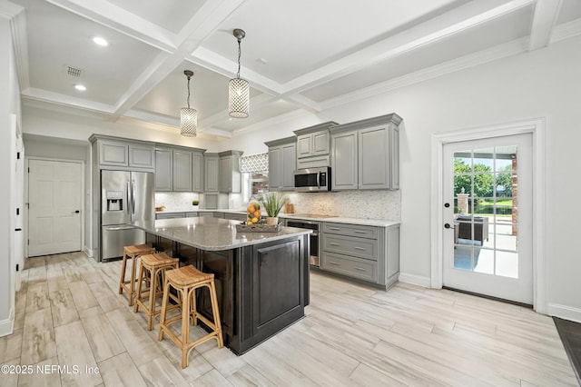 8483 Stables Rd, Jacksonville, FL 32256 - kitchen with gray cabinets, stainless steel appliances, beam ceiling, backsplash, and a kitchen island