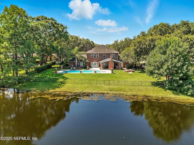 8483 Stables Rd, Jacksonville, FL 32256 - rear view of property with a fenced backyard, a chimney, a patio, and a water view