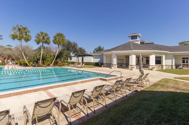 8483 Stables Rd, Jacksonville, FL 32256 - community pool with a patio and a yard