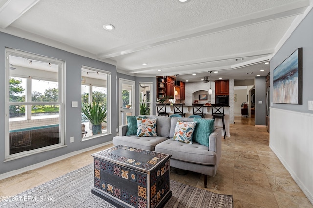 1786 Selva Marina Dr, Atlantic Beach, FL 32233 - living area with healthy amount of natural light, stone tile floors, a textured ceiling, beamed ceiling, and recessed lighting