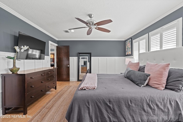 1786 Selva Marina Dr, Atlantic Beach, FL 32233 - bedroom with light wood finished floors, crown molding, a wainscoted wall, a textured ceiling, and ceiling fan