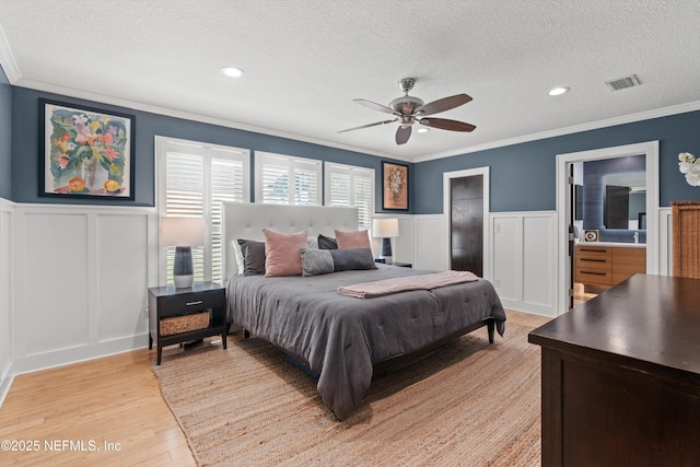 1786 Selva Marina Dr, Atlantic Beach, FL 32233 - bedroom with a decorative wall, crown molding, a textured ceiling, light wood finished floors, and a ceiling fan