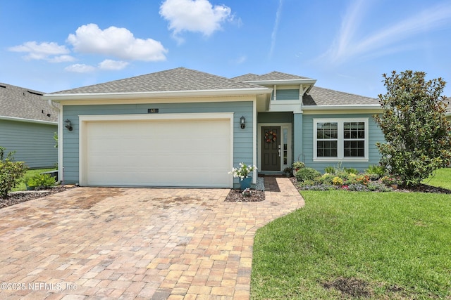 68 Ash Breeze Cv, Saint Augustine, FL 32095 - view of front of house featuring decorative driveway, a front yard, an attached garage, and roof with shingles
