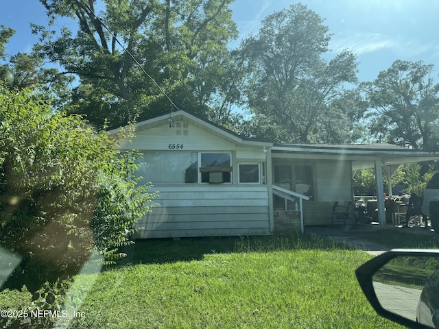 6554 New Kings Rd, Jacksonville, FL 32219 - back of house with a lawn