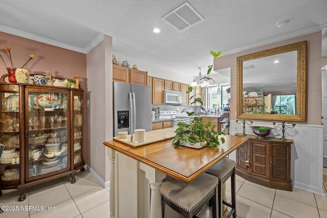5811 Atlantic Blvd Unit 25, Jacksonville, FL 32207 - kitchen with white appliances, light countertops, light tile patterned flooring, crown molding, and a textured ceiling