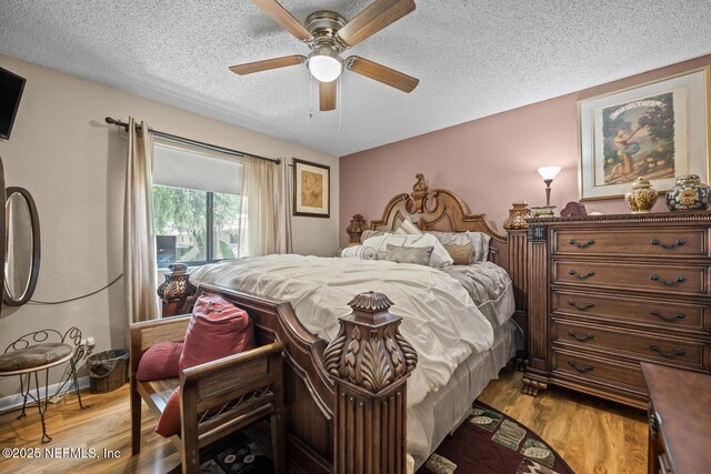 5811 Atlantic Blvd Unit 25, Jacksonville, FL 32207 - bedroom with a textured ceiling, wood finished floors, and a ceiling fan