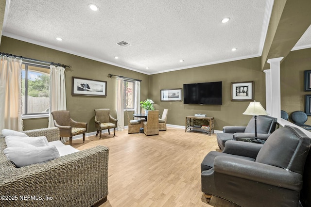 5811 Atlantic Blvd Unit 25, Jacksonville, FL 32207 - living room featuring ornate columns, ornamental molding, a textured ceiling, light wood-type flooring, and recessed lighting