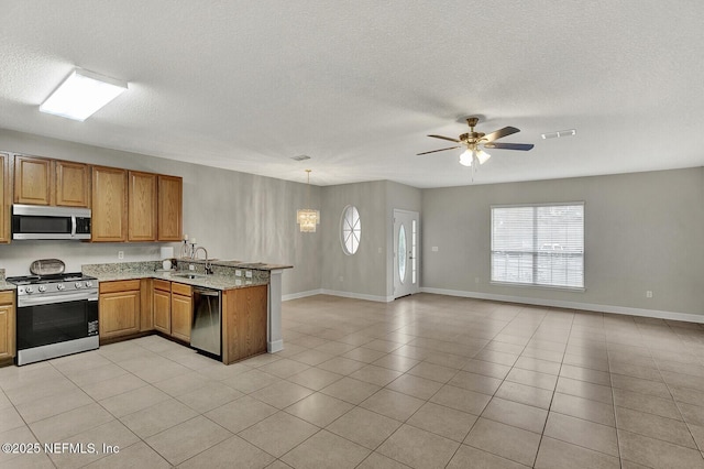 3164 Ravines Rd, Middleburg, FL 32068 - kitchen featuring stainless steel appliances, a peninsula, open floor plan, ceiling fan, and a textured ceiling