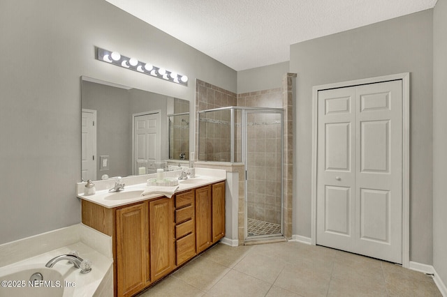3164 Ravines Rd, Middleburg, FL 32068 - bathroom featuring a shower stall, double vanity, tile patterned flooring, a garden tub, and a textured ceiling